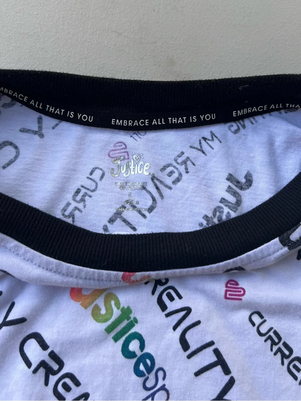 Justice White Tee with Black Trim and Multicolor Logo Print